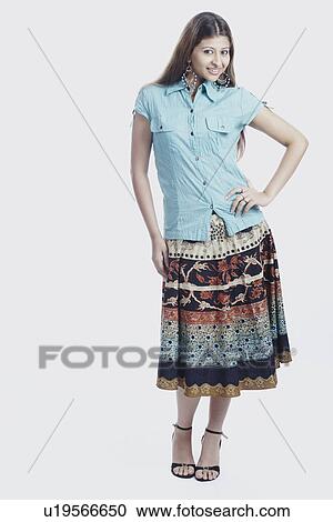 Portrait of a young woman with her hand on her hip View Large Photo Image Stock Image - Portrait of a young woman with her hand on her hip. Fotosearch