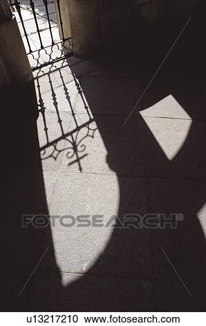 Stock Image - Urban, Interior, Iron gate, Grating, Grille, Shadow, Cross. Fotosearch