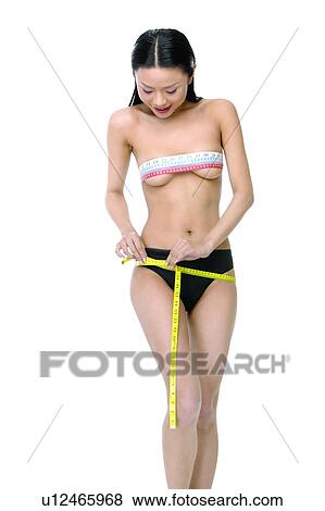 Stock Photo - Asian Ethnicity, Close-Up, Black Hair, Belly Button, Accuracy. Fotosearch