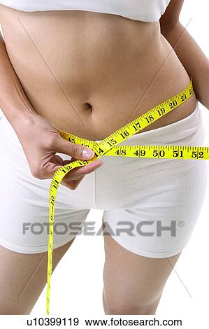 Stock Photo - Holding, Measuring, Dieting, Slim. Fotosearch