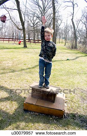 Boy age 5 posing as statue View Large Photo Image Stock Photo - Boy age 5 posing as statue. Fotosearch