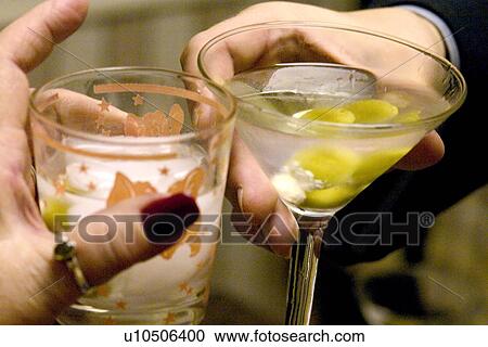 Stock Image - A martini clinking of the glasses. Fotosearch