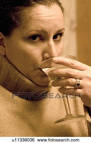 Stock Photograph - Woman sipping her martini. Fotosearch