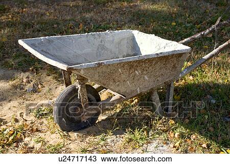 Stock Image - Portrait of a working wheelbarrow on the farm in Poland. Fotosearch