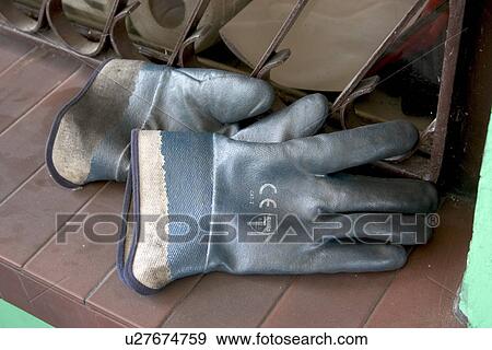 Stock Photo - Work gloves by a fence in Poland. Fotosearch