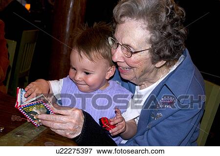 Great grandmother reading book to great grandson View Large Photo Image Stock Photo - Great grandmother reading book to great grandson. Fotosearch