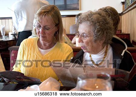 Stock Photo - Guests reading a menu. Fotosearch
