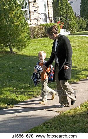 Stock Photo - Mom asking son how his day at school went. Fotosearch