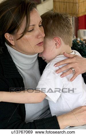 Mom comforting son ages 34 and 4 after a playtime incident View Large Photo Image Stock Photo - Mom comforting son ages 34 and 4 after a playtime incident. Fotosearch