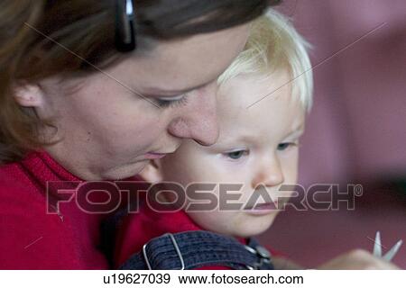 Mother helping son View Large Photo Image Stock Photo - Mother helping son. Fotosearch
