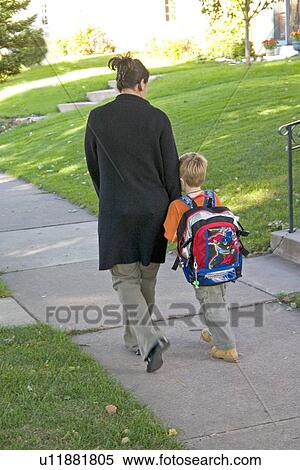 Stock Photography - Son needing a little comfort from mom after ride on school bus. St Paul Minnesota USA. Fotosearch