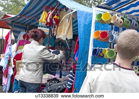 Cups and clothes for sale at the market View Large Photo Image Stock Photo - Cups and clothes for sale at the market. Fotosearch