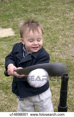 A mighty swing by a very advanced one year old T ball player View Large Photo Image Stock Image - A mighty swing by a very advanced one year old T ball player. Fotosearch