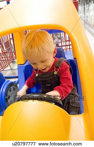 Toddler having the time of his life in Galeria shopping car View Large Photo Image Stock Photo - Toddler having the time of his life in Galeria shopping car. Fotosearch
