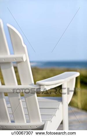 Adirondack chairs on deck looking towards beach on Bald Head Island, North Carolina. View Large Photo Image Stock Photo - Adirondack chairs on deck looking towards beach on Bald Head Island, North Carolina.. Fotosearch