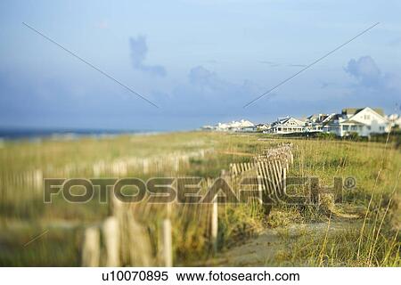 Stock Photography - Beachfront houses separated from ocean by natural area.. Fotosearch