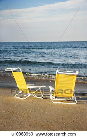 Empty lounge chairs on beach on Bald Head Island, North Carolina. View Large Photo Image Stock Image - Empty lounge chairs on beach on Bald Head Island, North Carolina.. Fotosearch
