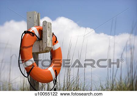 Life preserver hanging on post on beach on Bald Head Island, North Carolina. View Large Photo Image Stock Image - Life preserver hanging on post on beach on Bald Head Island, North Carolina.. Fotosearch