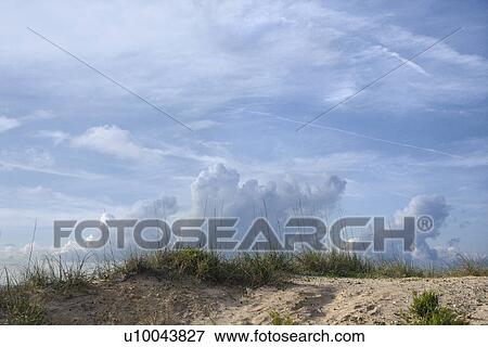 Sand dune with beach grass and cloudy sky. View Large Photo Image Stock Photo - Sand dune with beach grass and cloudy sky.. Fotosearch