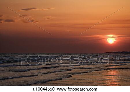 Sun setting over beach on Bald Head Island, North Carolina. View Large Photo Image Stock Image - Sun setting over beach on Bald Head Island, North Carolina.. Fotosearch