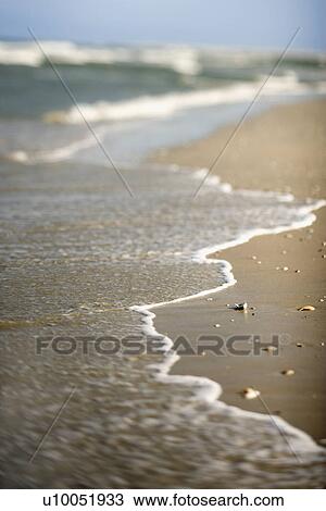 Stock Image - Waves coming onto shore.. Fotosearch