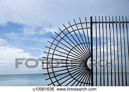 Decorative wrought iron fence at the edge of the sea. View Large Photo Image Stock Photograph - Decorative wrought iron fence at the edge of the sea.. Fotosearch