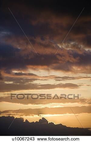 Golden sunset with glowing cloud edges in Maui, Hawaii, USA. View Large Photo Image Stock Image - Golden sunset with glowing cloud edges in Maui, Hawaii, USA.. Fotosearch