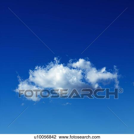 Stock Image - Lone puffy cumulus cloud in blue sky.. Fotosearch