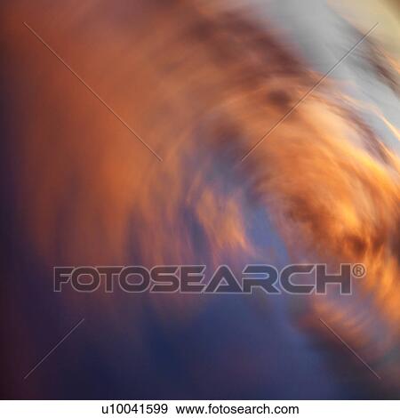 Spiral orange clouds in sky with sunset. View Large Photo Image Stock Photo - Spiral orange clouds in sky with sunset.. Fotosearch