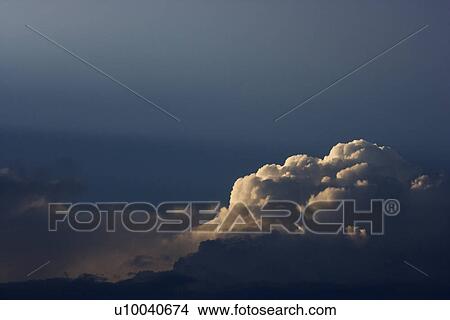Picture - Sun peeking through clouds.. Fotosearch