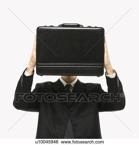 Caucasian man wearing suit and holding briefcase in front of face. View Large Photo Image Stock Photograph - Caucasian man wearing suit and holding briefcase in front of face.. Fotosearch