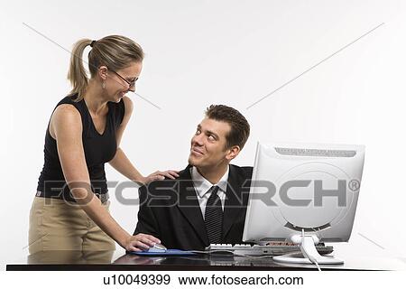 Caucasian mid-adult woman touching mid-adult man's shoulder and using mouse at computer. View Large Photo Image Stock Photo - Caucasian mid-adult woman touching mid-adult man's shoulder and using mouse at computer.. Fotosearch