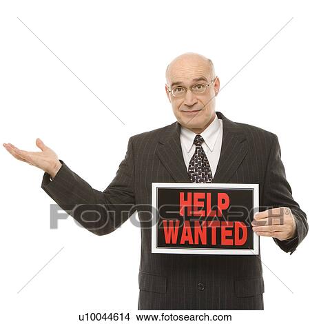 Caucasian middle-aged businessman holding help wanted sign. View Large Photo Image Picture - Caucasian middle-aged businessman holding help wanted sign.. Fotosearch