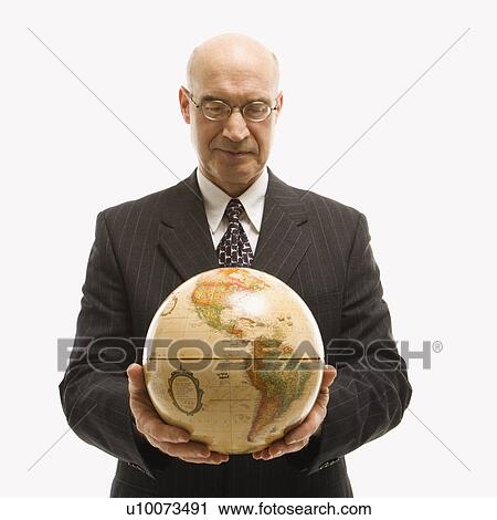 Caucasian middle-aged businessman holding globe in both hands standing in front of white background. View Large Photo Image Stock Image - Caucasian middle-aged businessman holding globe in both hands standing in front of white background.. Fotosearch