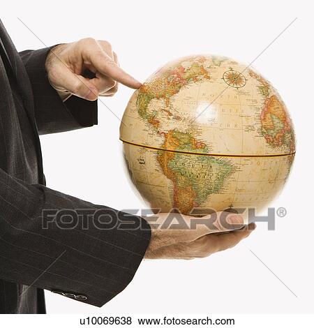 Caucasian middle-aged businessman holding globe and pointing standing in front of white background. View Large Photo Image Stock Photo - Caucasian middle-aged businessman holding globe and pointing standing in front of white background.. Fotosearch