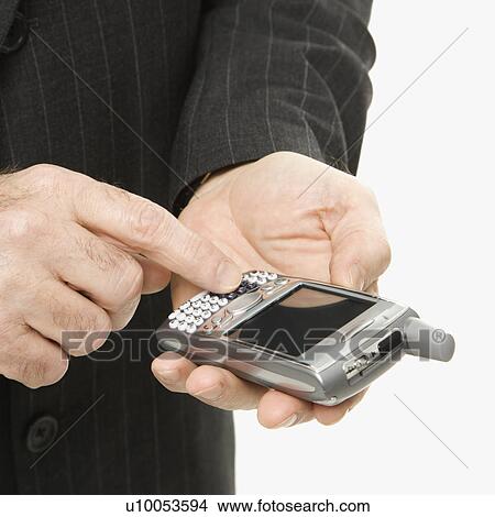 Picture - Close-up of Caucasian middle-aged businessman using handheld PDA.. Fotosearch