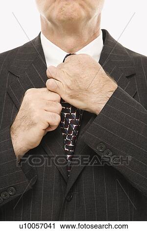 Close-up of Caucasian middle-aged businessman straightening necktie. View Large Photo Image Stock Image - Close-up of Caucasian middle-aged businessman straightening necktie.. Fotosearch