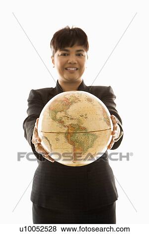 Filipino middle-aged businesswoman holding globe in both hands standing in front of white background. View Large Photo Image Stock Photo - Filipino middle-aged businesswoman holding globe in both hands standing in front of white background.. Fotosearch