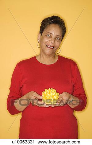 African American mature adult female holding present. View Large Photo Image Stock Image - African American mature adult female holding present.. Fotosearch