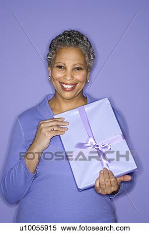African American mature adult female holding present. View Large Photo Image Stock Photography - African American mature adult female holding present.. Fotosearch