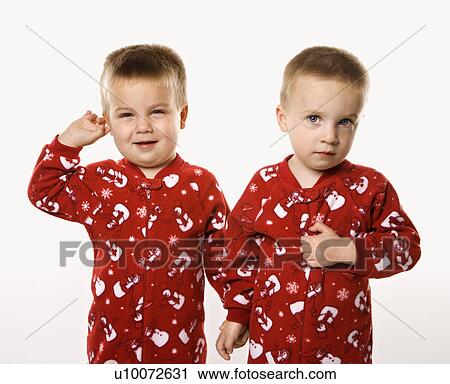 Stock Image - Caucasian male twin children holding hands.. Fotosearch