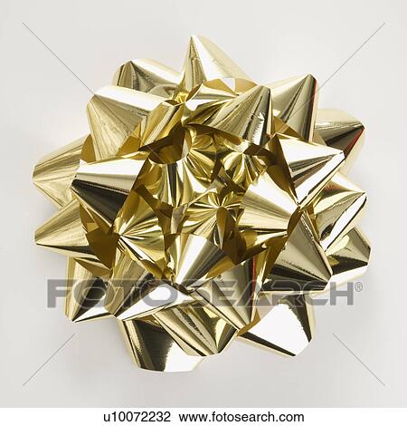 Still life of big shiny gold Christmas bow. View Large Photo Image Stock Image - Still life of big shiny gold Christmas bow.. Fotosearch