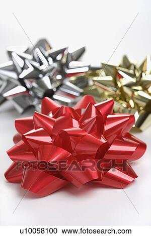 Still life of big shiny red, gold and silver Christmas bows. View Large Photo Image Stock Image - Still life of big shiny red, gold and silver Christmas bows.. Fotosearch