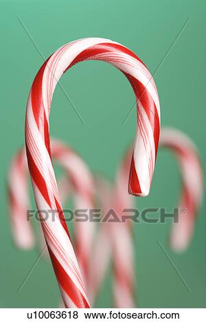 Still life of candy cane with blurred out candy canes in background. View Large Photo Image Stock Photo - Still life of candy cane with blurred out candy canes in background.. Fotosearch