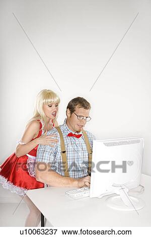 Stock Photo - Caucasian young man dressed like nerd with Caucasian young blonde woman dressed in french maid outfit looking over shoulder.. Fotosearch