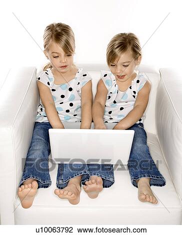 Female children Caucasian twins playing with laptop computer. View Large Photo Image Stock Image - Female children Caucasian twins playing with laptop computer.. Fotosearch