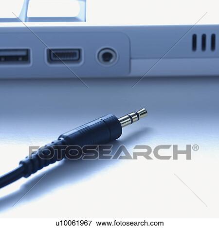 Stock Photo - Headphone wire disconnected from computer.. Fotosearch