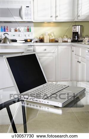 Open laptop computer on top of glass top kitchen table. View Large Photo Image Stock Image - Open laptop computer on top of glass top kitchen table.. Fotosearch