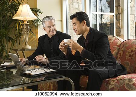 Picture - Prime adult Asian and Caucasian businessmen.. Fotosearch