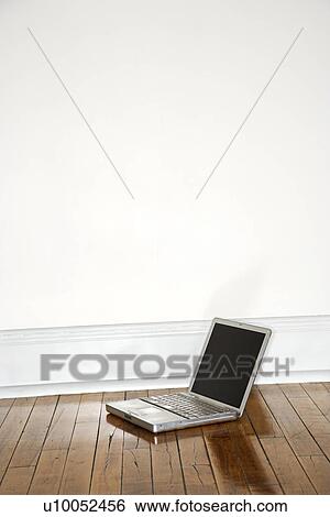 Still life of laptop on hardwood floor. View Large Photo Image Stock Photograph - Still life of laptop on hardwood floor.. Fotosearch